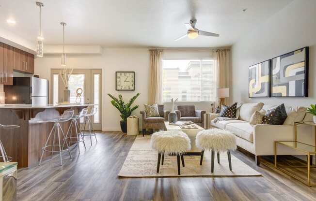 a living room with hardwood flooring and a ceiling fan