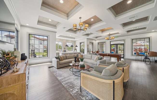 A modern living room with a large sofa set and a wooden floor.