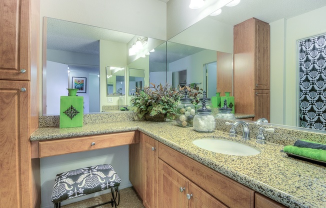 A bathroom with a green bottle on the counter.