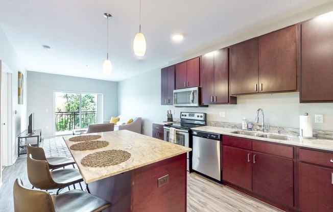 a kitchen with wooden cabinets and a marble counter top