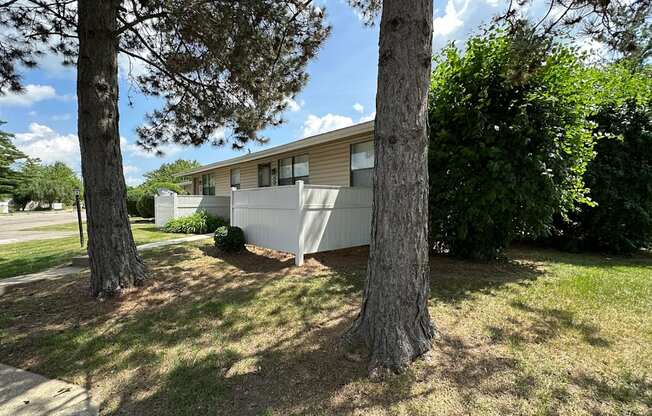 A house with a tree in front of it.