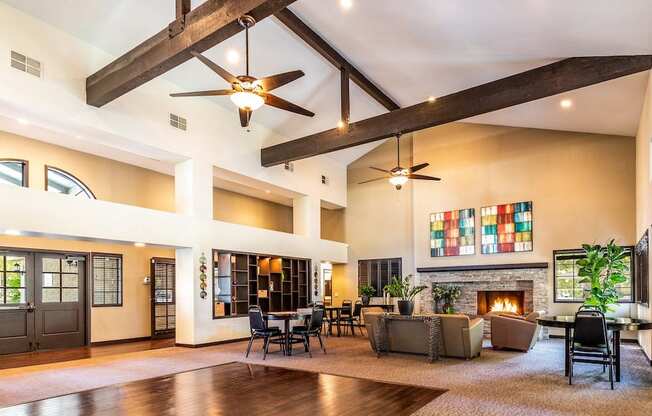 a large living room with a fireplace and a colorful painting on the wall