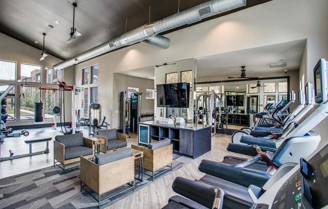 Apartments for Rent Grand Prairie TX - Fitness Center With Weight Machines, Cardio Machines, TV and Seating Area