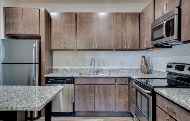 Flats Kitchen with granite countertops and dark wood cabinets