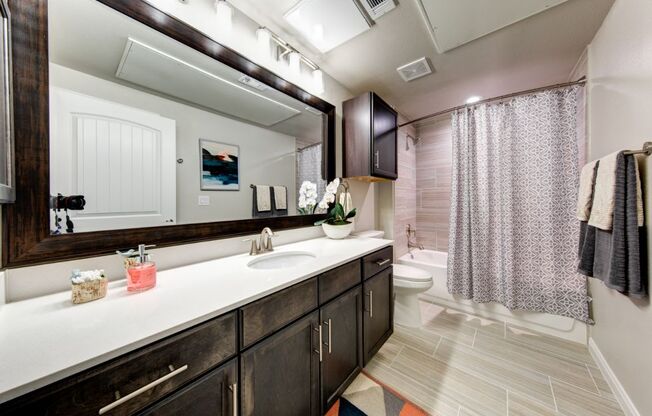 a bathroom with a large mirror and a sink