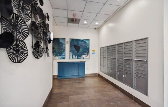 Mailroom at the gym with paintings on the wall