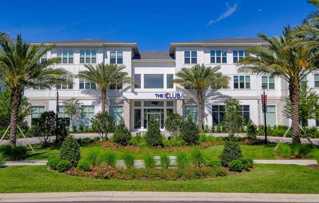 a building with palm trees in front of it at Altis Grand Lake Willis, Florida
