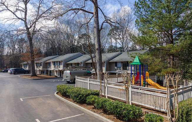 a parking lot filled with houses with playground equipment