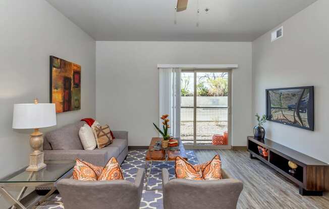 a living room with gray walls and a sliding glass door at Allora Phoenix Apartments, Arizona, 85021