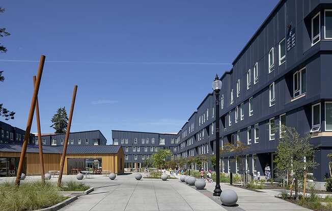 a courtyard in front of a building with a blue sky in the background