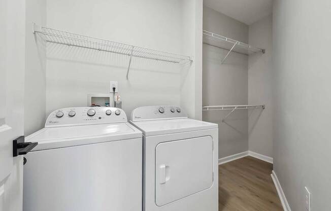 A white washing machine and dryer in a laundry room.
