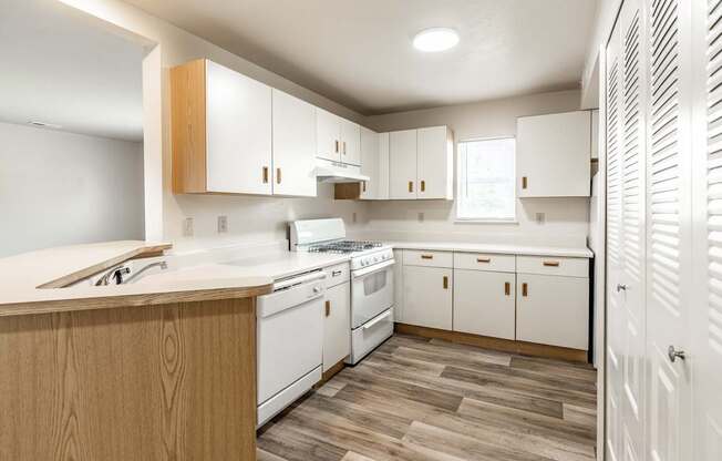 A kitchen with white appliances and wooden cabinets