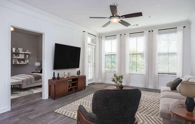 A living room with a black chair in the center.