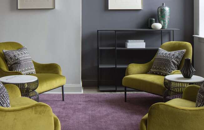 Three yellow chairs with pillows are arranged in a room.