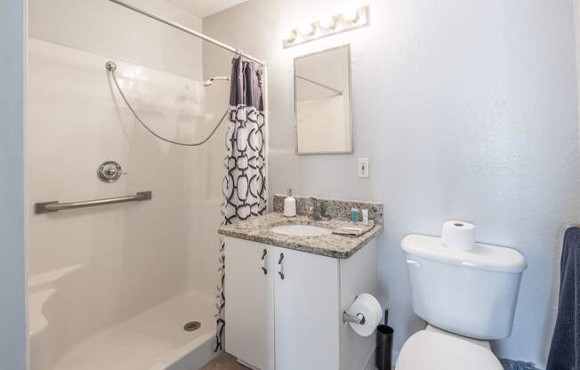 a bathroom with a sink toilet and shower