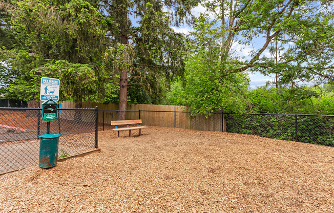 A dog park with a sign and a bench.