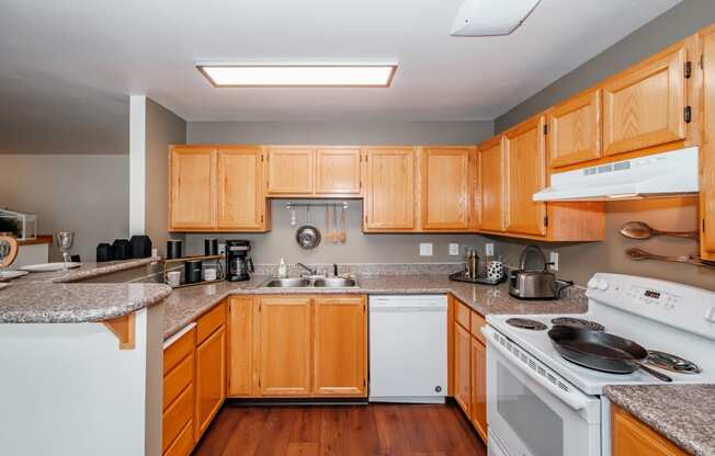 a kitchen with wooden cabinets and granite countertops