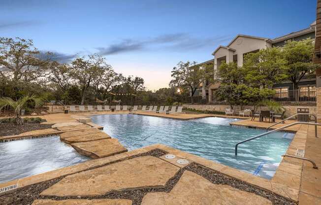 A large outdoor pool surrounded by stone walkways.