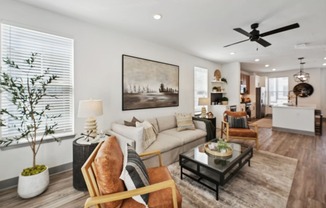 a living room with a ceiling fan and a couch at Meridian at CityPlace, Woodbury, Minnesota