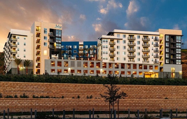 a rendering of a building with a brick wall in front of it