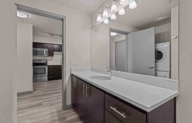 A modern kitchen with dark wood cabinets and white countertops.