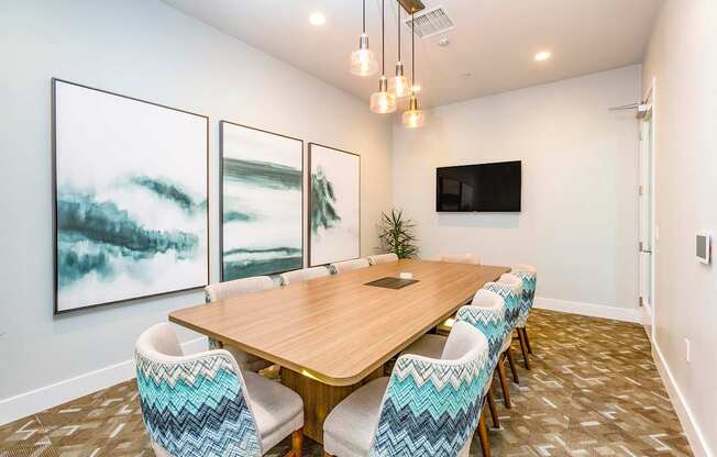 A conference room with a long table and chairs.