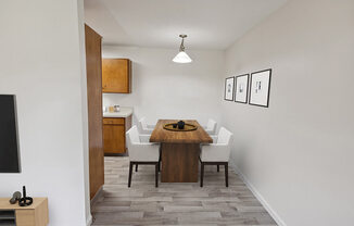 Model Dining Room with Wood-Style Flooring at Walnut Creek Apartments located in Walnut Creek, CA.