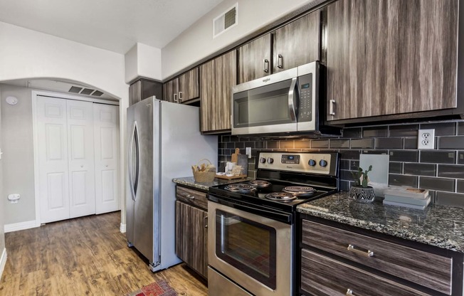 a kitchen with stainless steel appliances and wooden cabinets