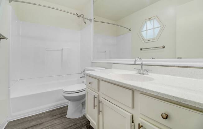 a bathroom with a sink toilet and a bath tub