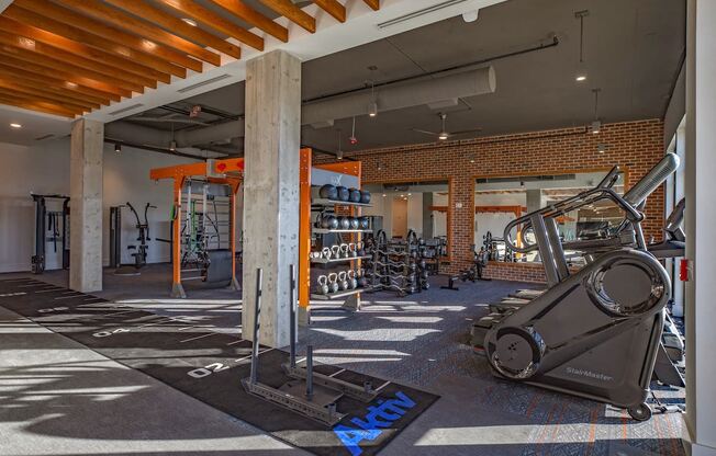a gym with a lot of machines and weights in it