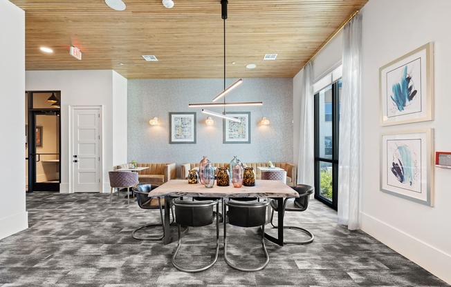 A dining room with a table set for six people.