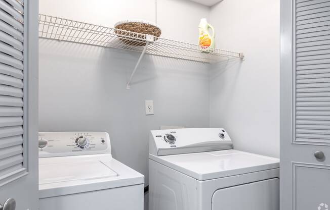 a small laundry room with two washes and a dryer