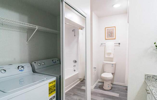 A small laundry room with a washer and dryer.