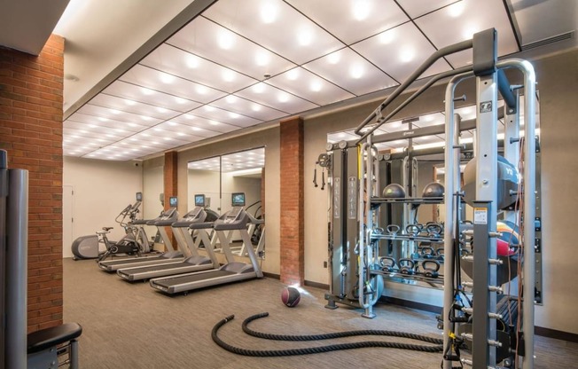 a gym with weights and cardio equipment in a building at Reed Row, Washington, 20009