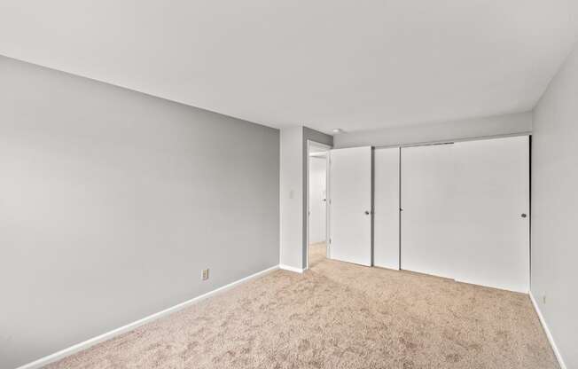 A room with a carpeted floor and white walls.