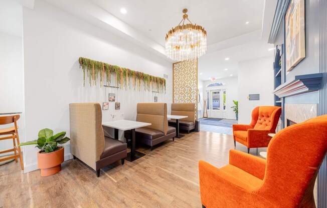 A room with orange chairs and a wooden table.