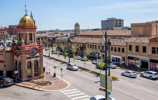 a view of a city street with a building with a clock tower