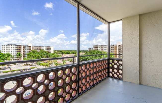 a balcony with a view of the city and trees