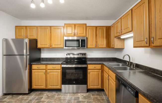 a kitchen with wooden cabinets and stainless steel appliances