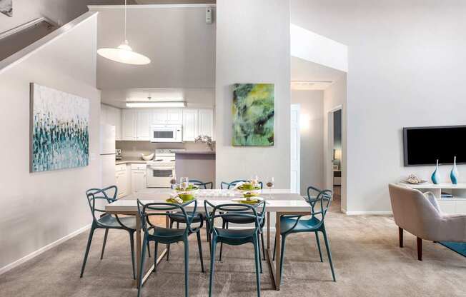 A modern dining room with a table set for four.