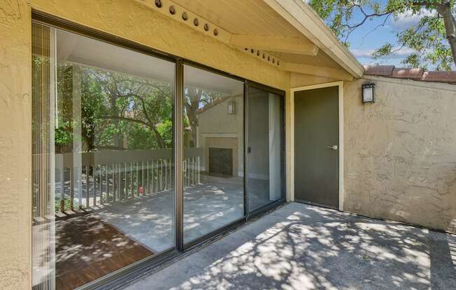 a patio with a glass door and a balcony at Summerwood Apartments, Santa Clara, 95050