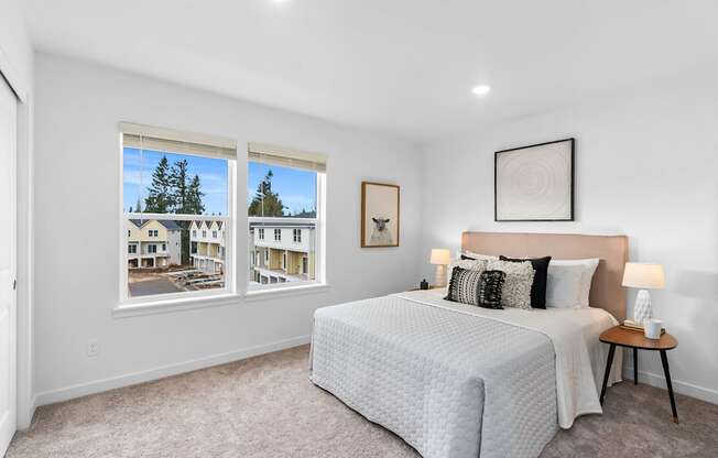 a bedroom with a bed and two windows