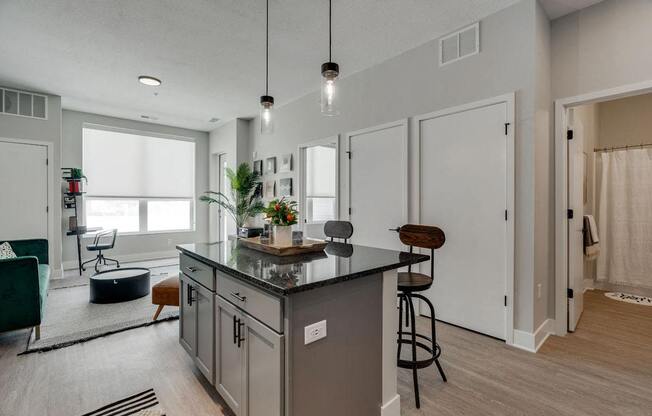 an open kitchen and living room with a counter top