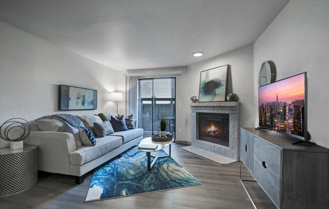 a living room with a couch a table and a fireplace