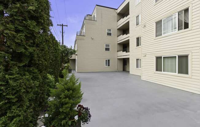 Outdoor Deck Area with Potted Flowers and smooth paving at Hill Crest Apartment Homes, Washington, 98126