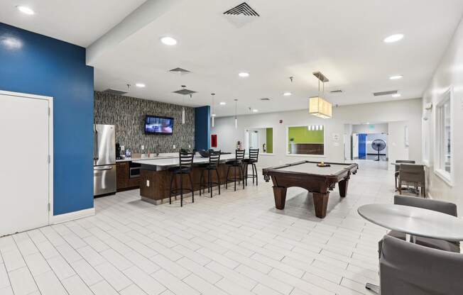 a clubhouse with a pool table and a bar and a tv