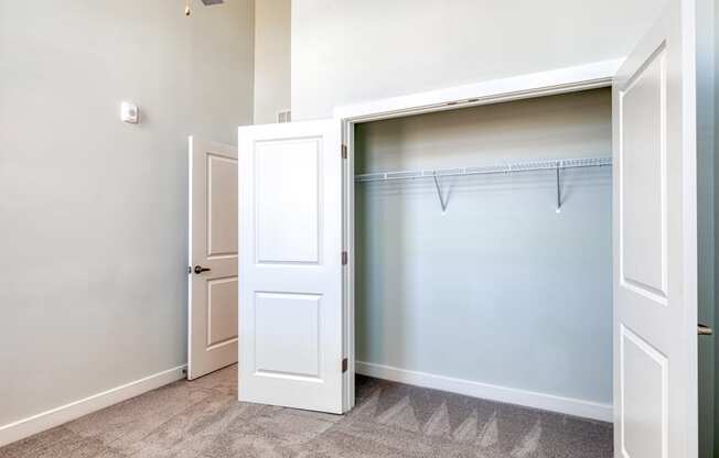 an empty closet in a home with a white door and a door to a closet at The Bella at Westchester, Midlothian