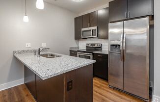 a kitchen with stainless steel appliances and a granite counter top