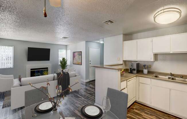 a living room and dining room with a table and chairs and a kitchen