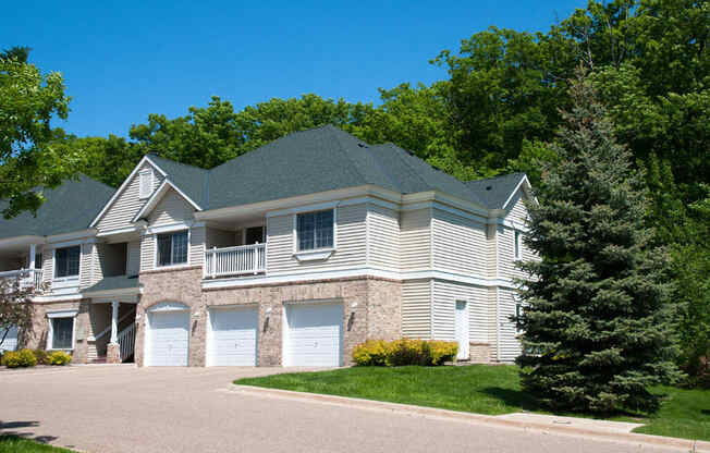 Townhome surrounded by lush green trees and grass